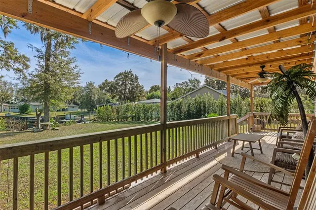 a view of a house with backyard and a tree