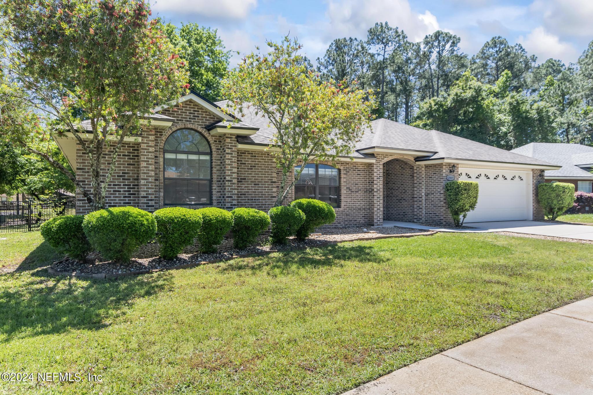 2949 Turning Leaf Lane Jacksonville, FL 32221 - Photo 18 of 116 a front view of a house with a garden
