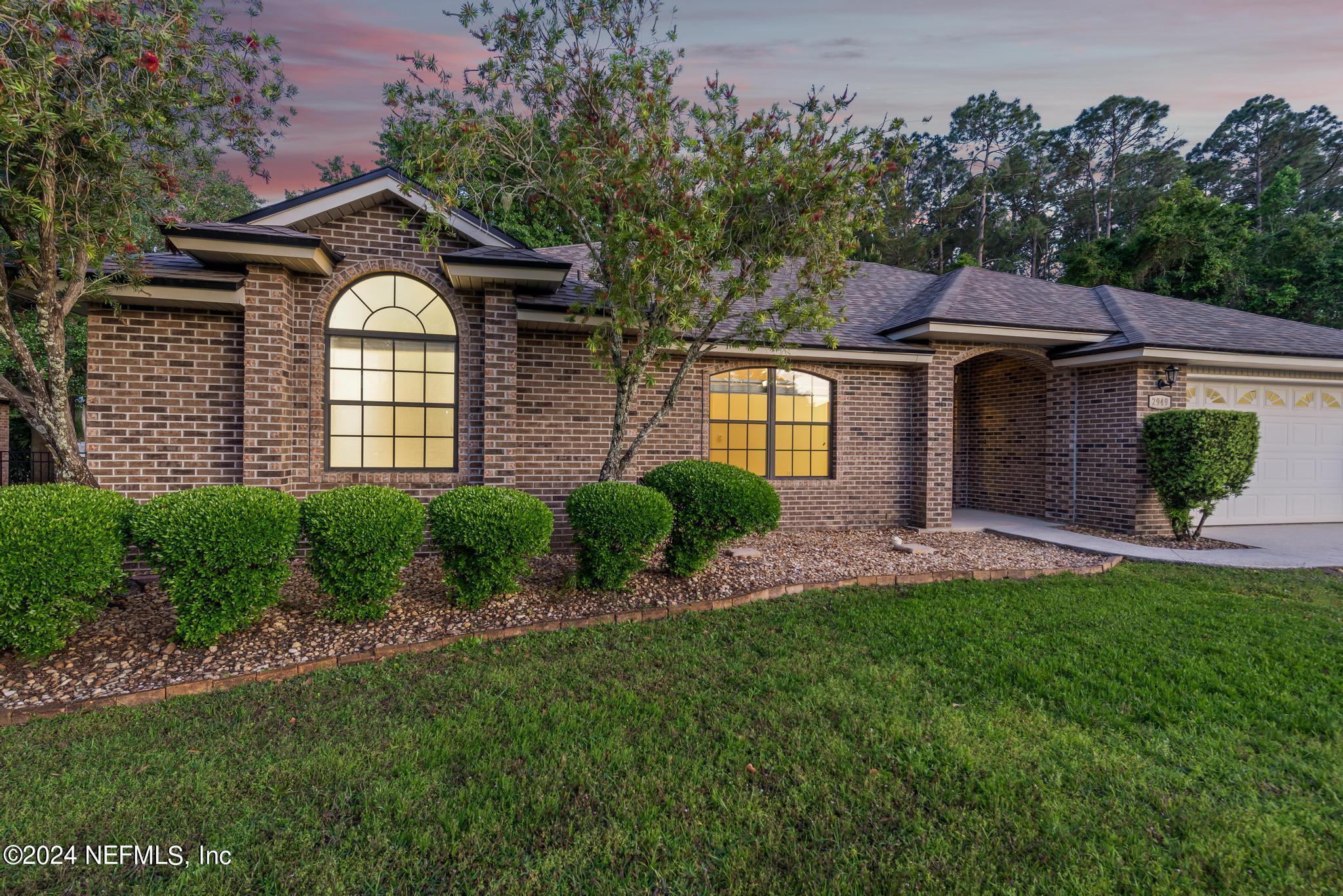 2949 Turning Leaf Lane Jacksonville, FL 32221 - Photo 2 of 116 a front view of a house with a yard