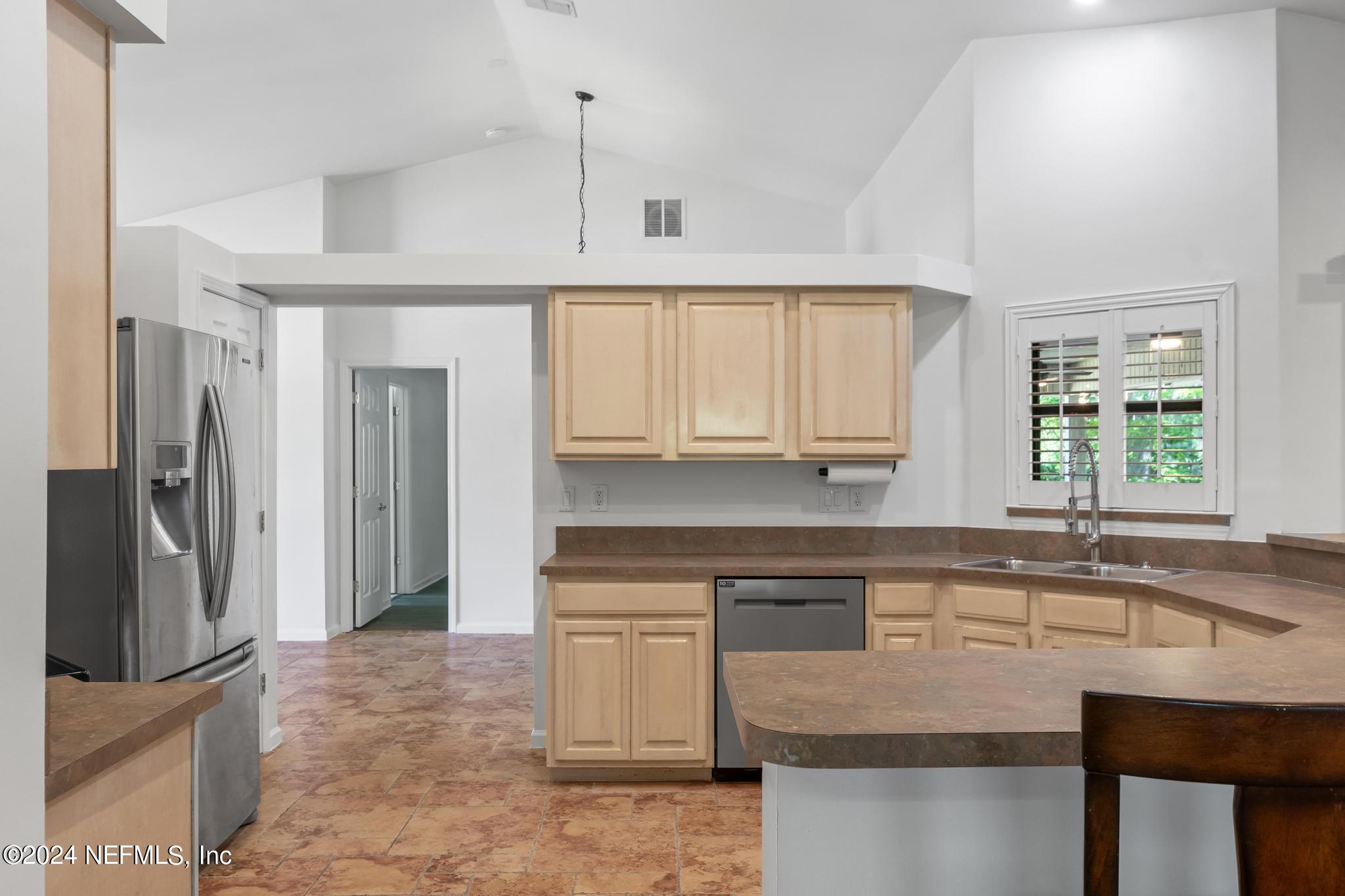 2949 Turning Leaf Lane Jacksonville, FL 32221 - Photo 41 of 116 a kitchen with stainless steel appliances granite countertop a sink and a refrigerator