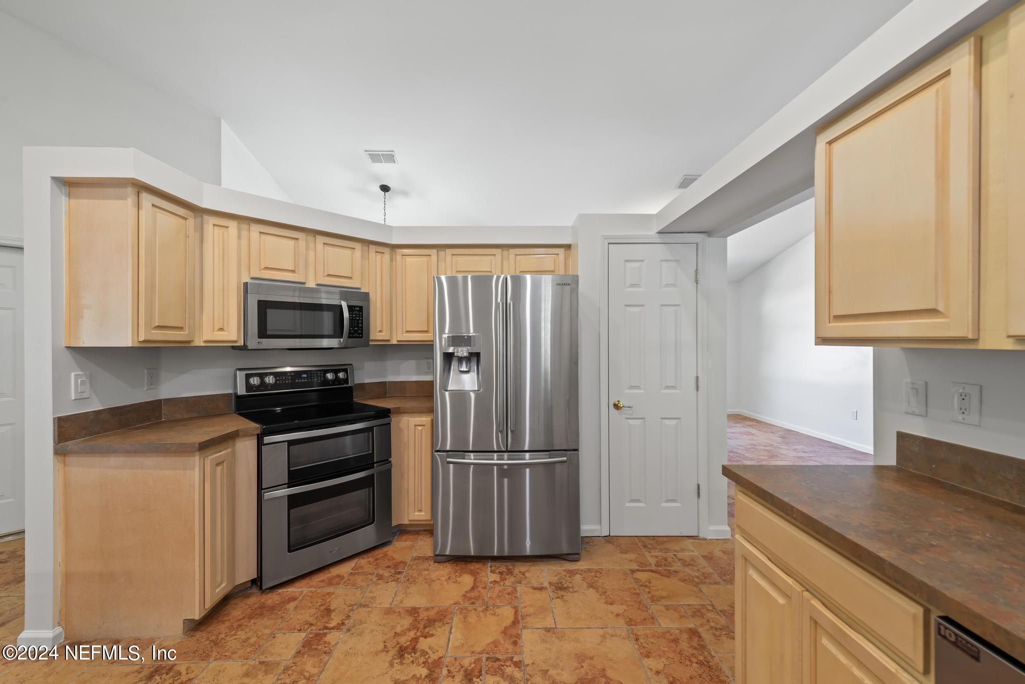 2949 Turning Leaf Lane Jacksonville, FL 32221 - Photo 43 of 116 a kitchen with stainless steel appliances granite countertop a refrigerator stove and sink