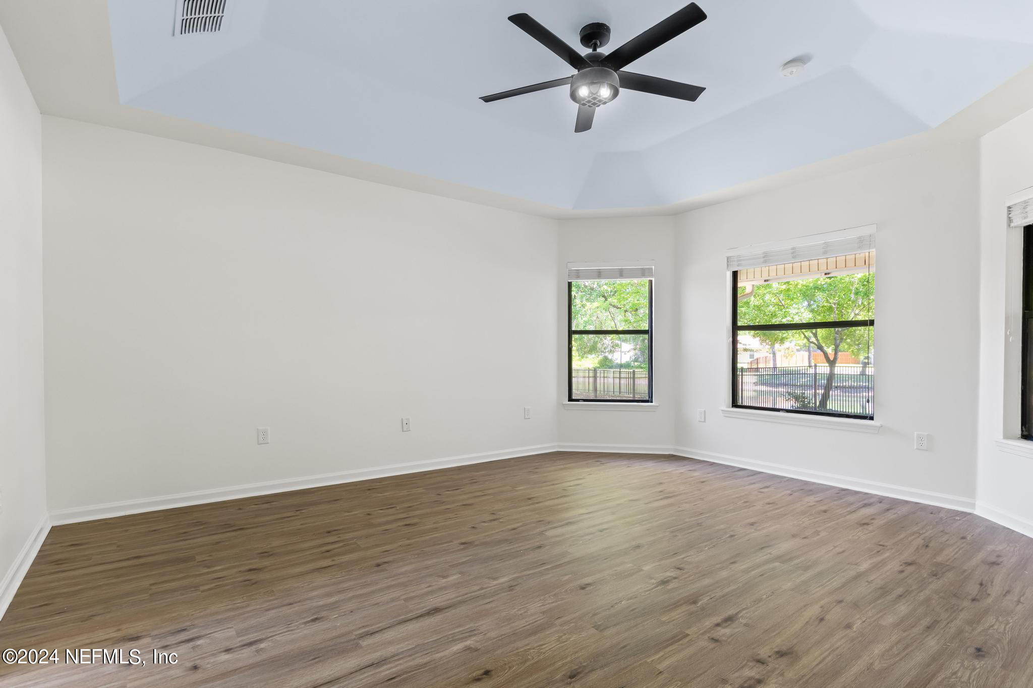 2949 Turning Leaf Lane Jacksonville, FL 32221 - Photo 59 of 116 an empty room with wooden floor fan and windows