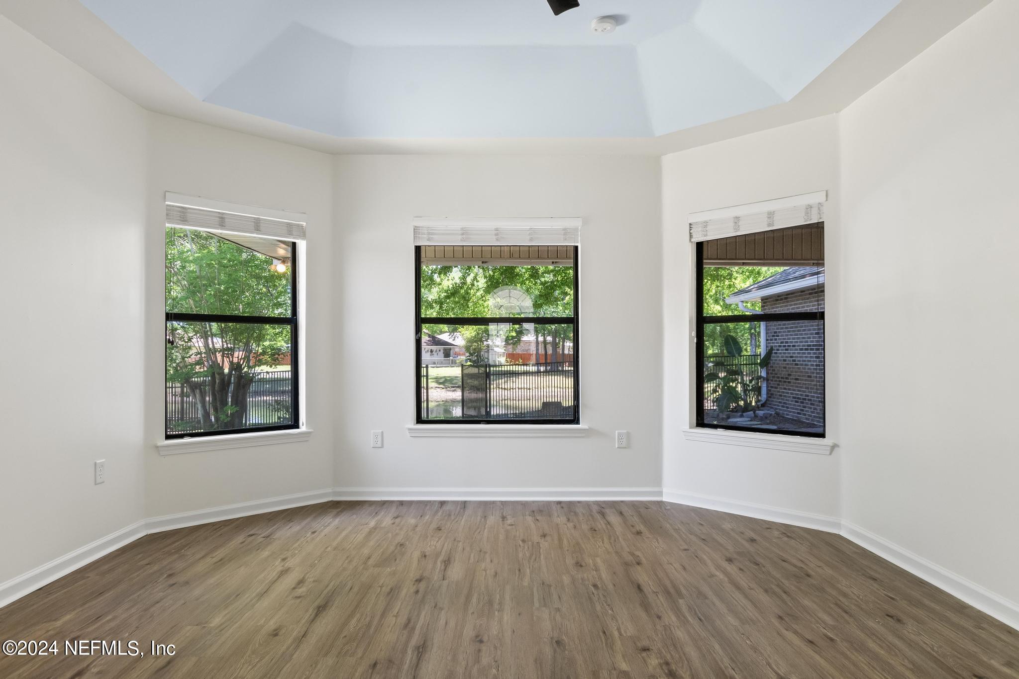 2949 Turning Leaf Lane Jacksonville, FL 32221 - Photo 62 of 116 an empty room with wooden floor and windows
