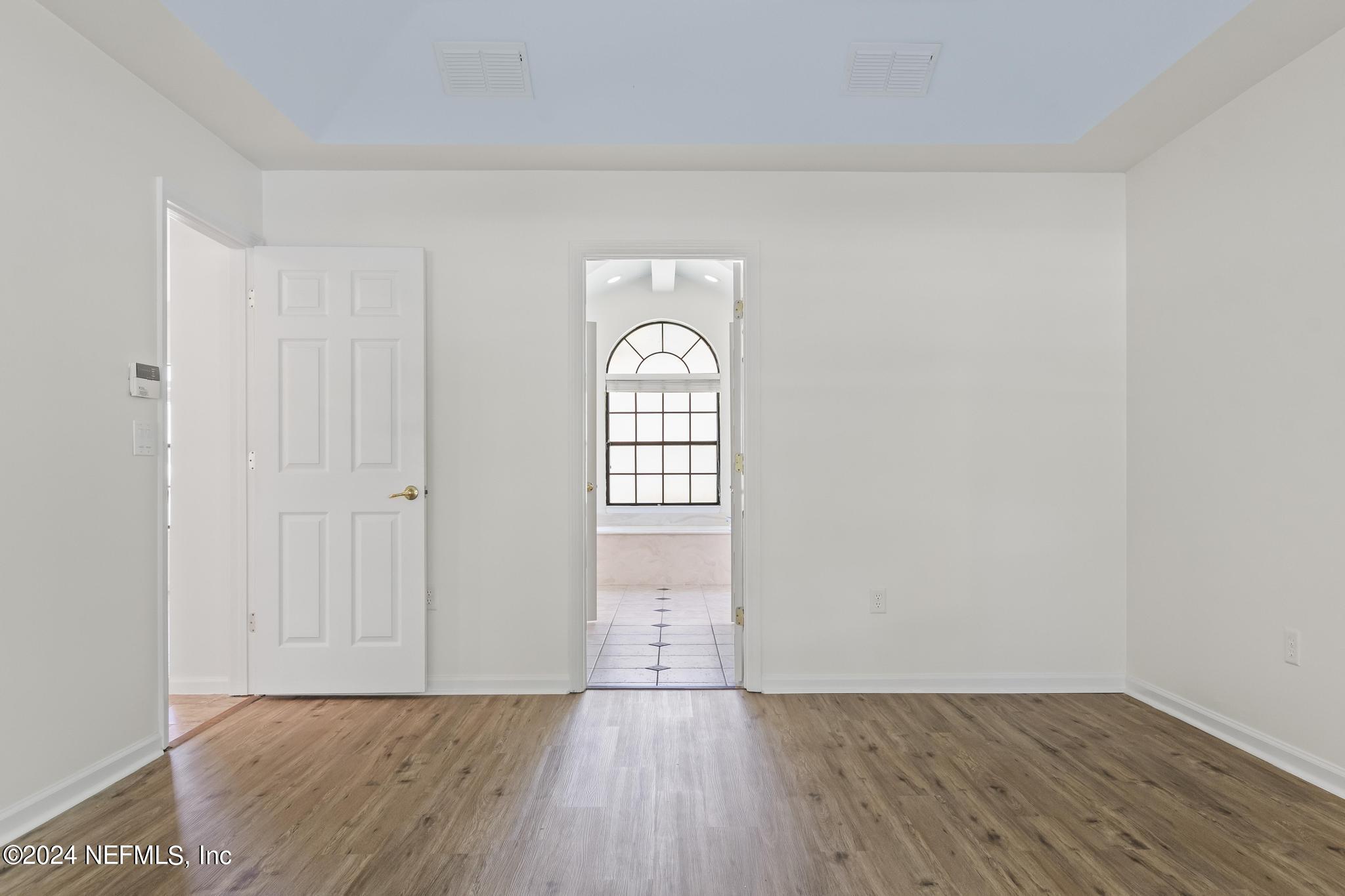 2949 Turning Leaf Lane Jacksonville, FL 32221 - Photo 64 of 116 a view of an empty room with wooden floor and a window