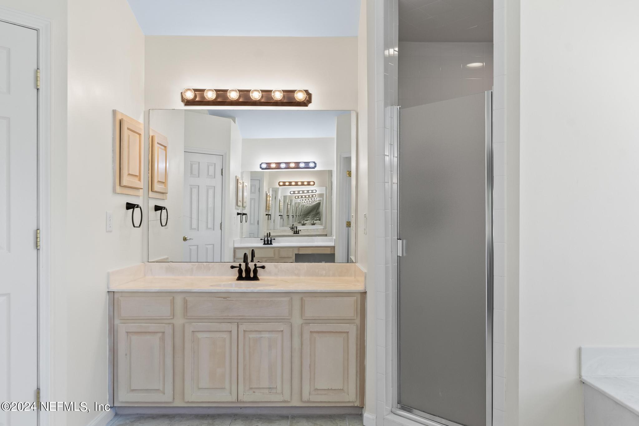 2949 Turning Leaf Lane Jacksonville, FL 32221 - Photo 74 of 116 a bathroom with a sink and a mirror