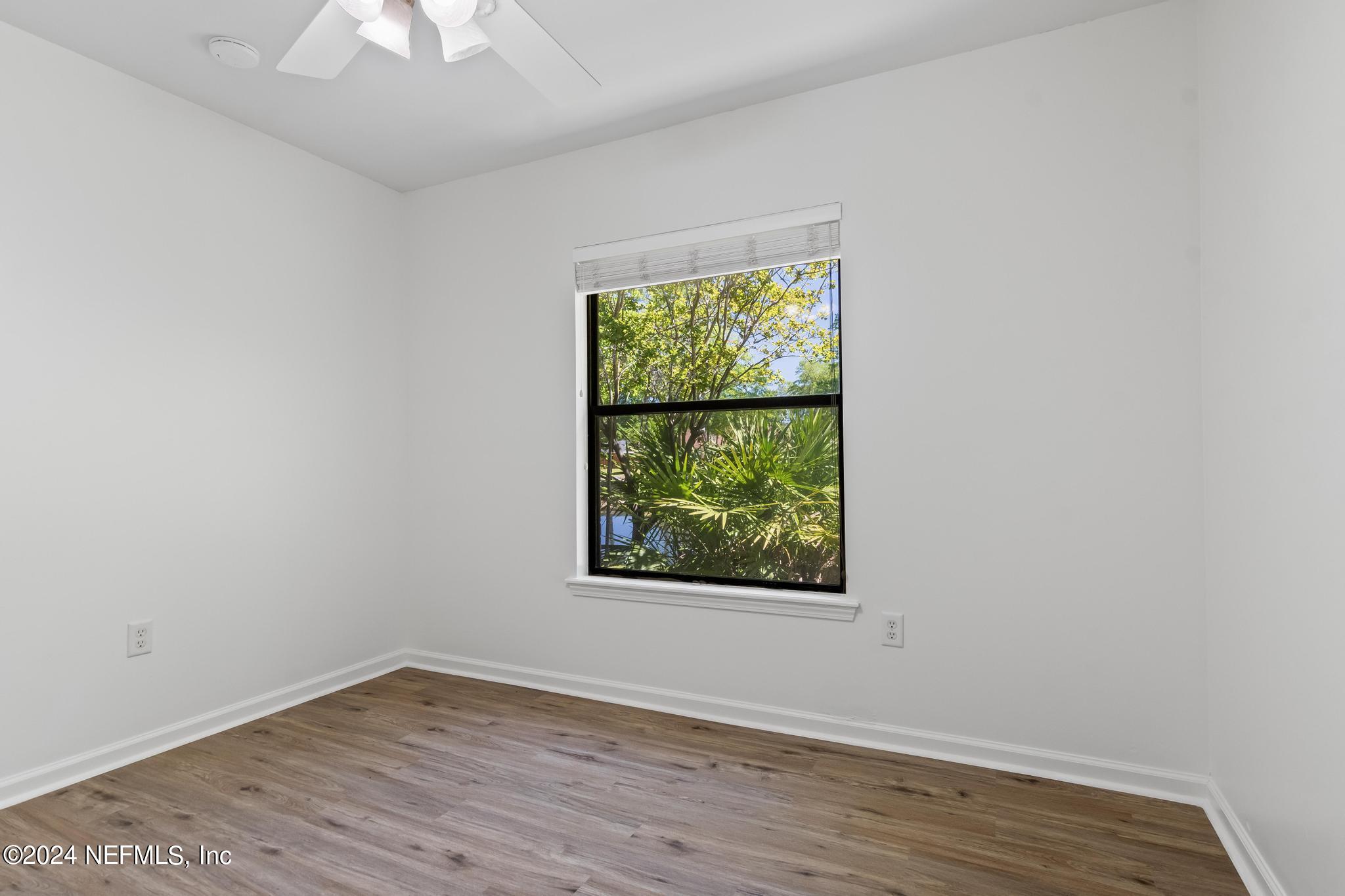 2949 Turning Leaf Lane Jacksonville, FL 32221 - Photo 87 of 116 an empty room with wooden floor and windows