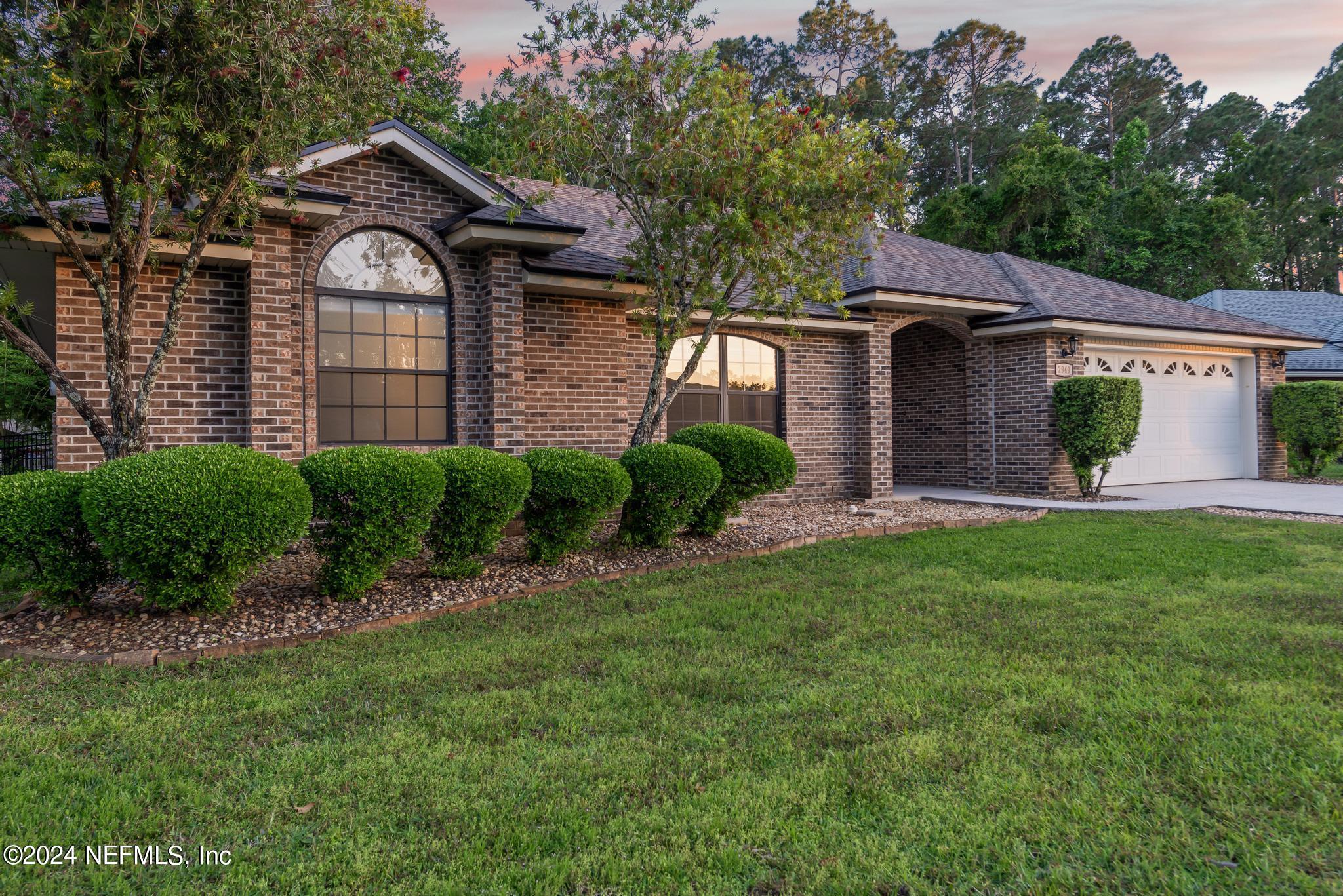 2949 Turning Leaf Lane Jacksonville, FL 32221 - Photo 9 of 116 a front view of a house with a garden and plants