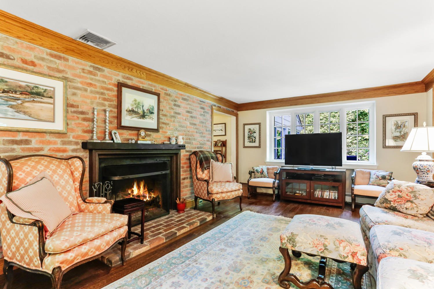 573 Valley Road New Canaan, CT 06840 - Photo 12 of 53 a living room with furniture a flat screen tv and a fireplace