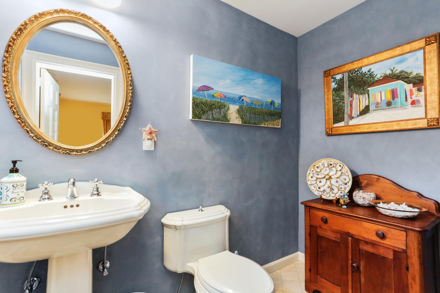 573 Valley Road New Canaan, CT 06840 - Photo 19 of 53 a bathroom with a toilet a sink and a mirror