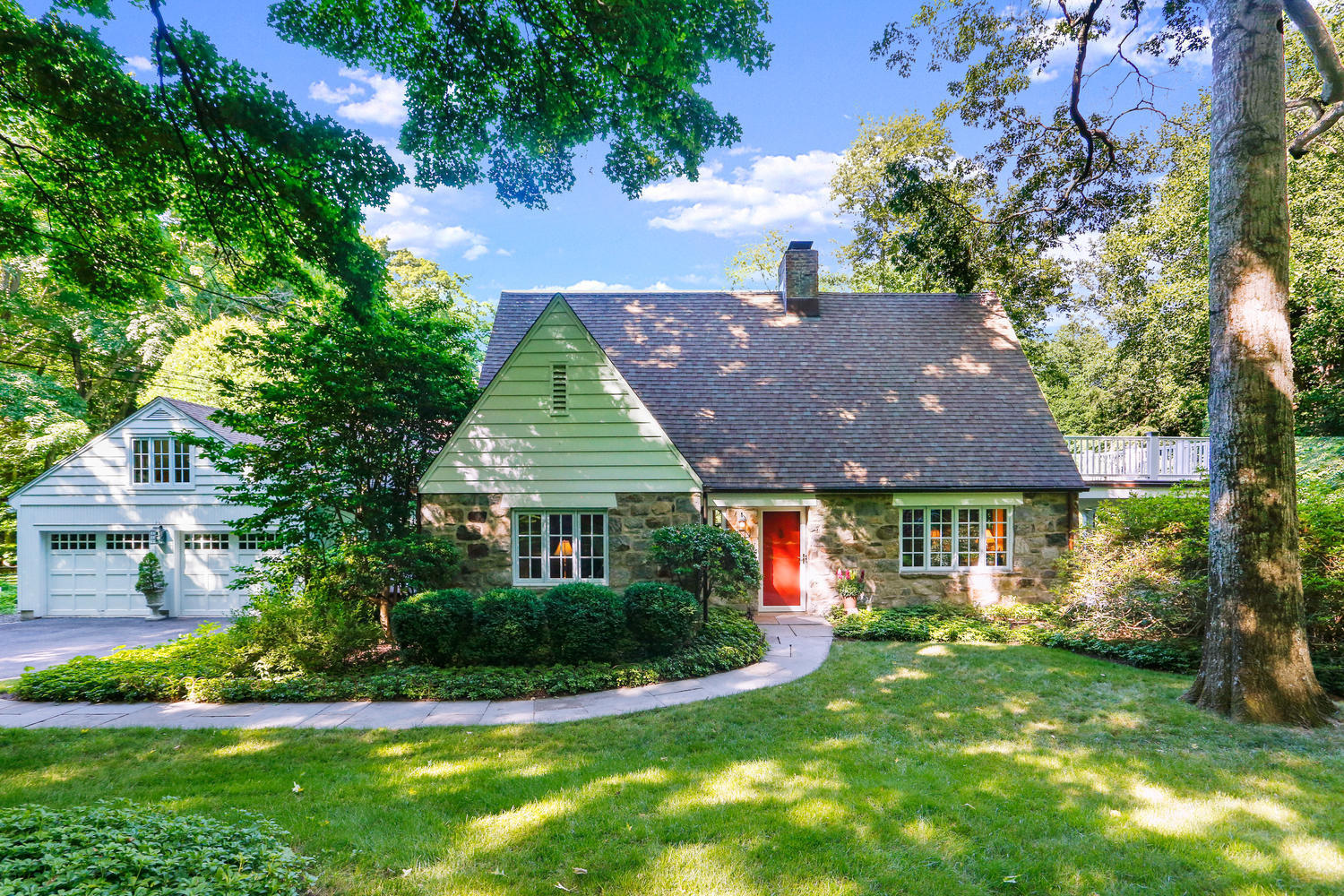 573 Valley Road New Canaan, CT 06840 - Photo 2 of 53 a front view of a house with a yard