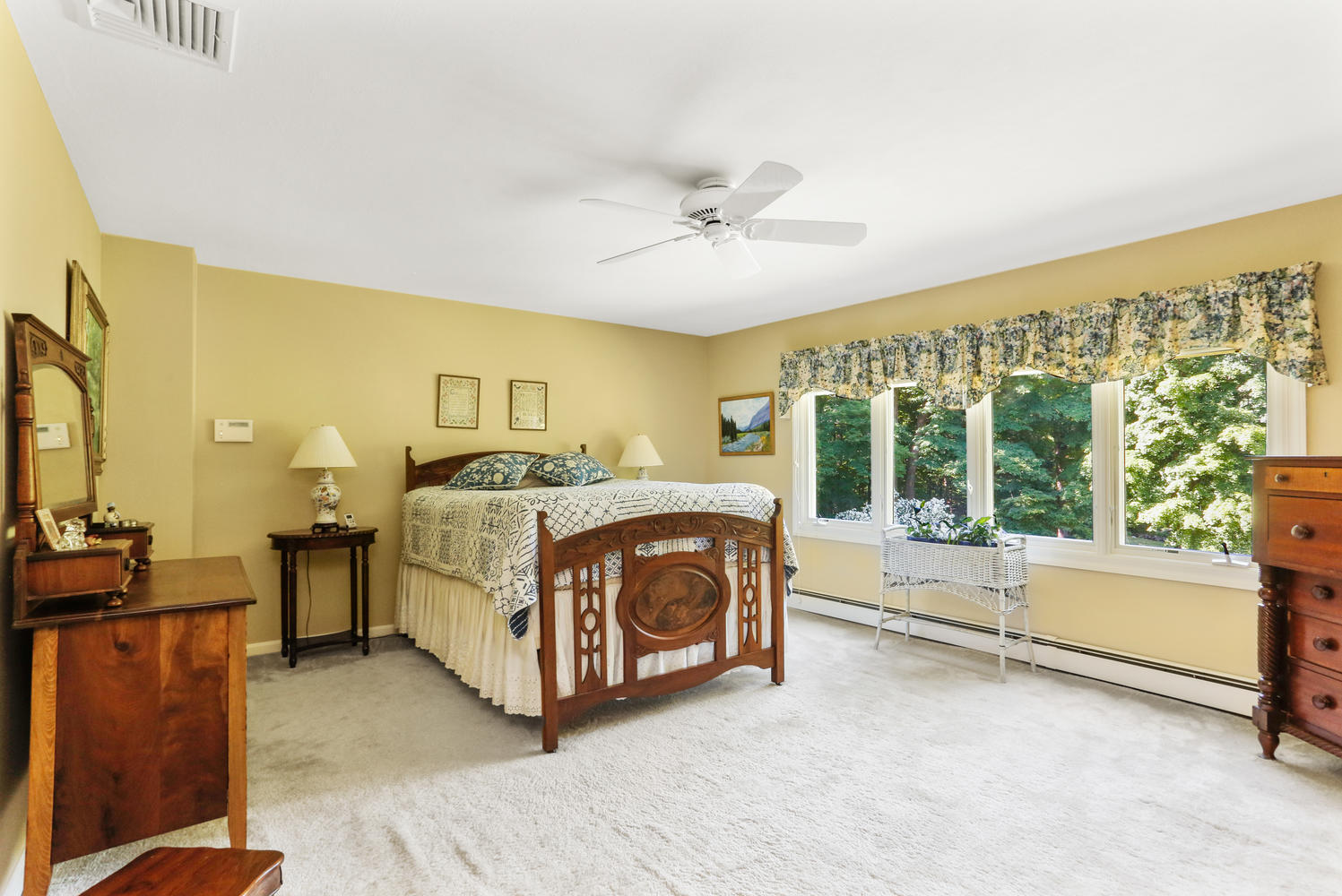 573 Valley Road New Canaan, CT 06840 - Photo 21 of 53 a spacious bedroom with a bed dresser and a large window