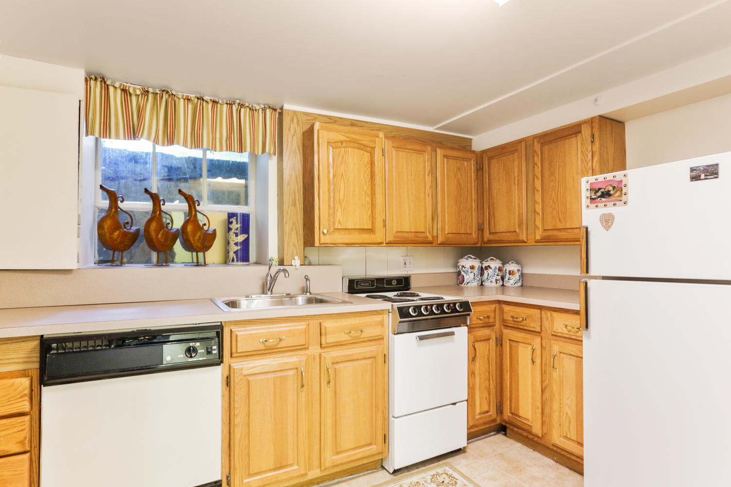 573 Valley Road New Canaan, CT 06840 - Photo 25 of 53 a white refrigerator freezer sitting inside of a kitchen