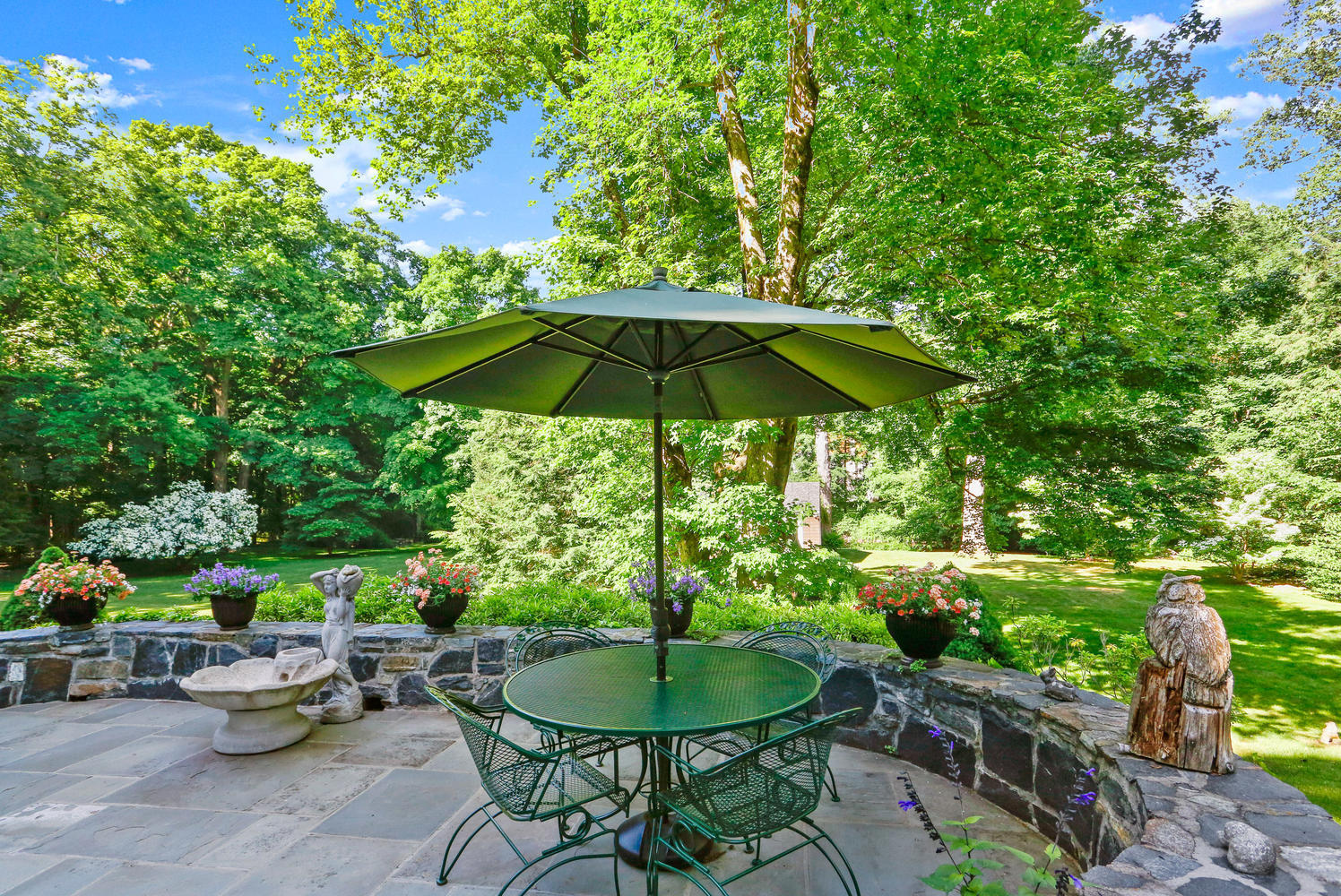 573 Valley Road New Canaan, CT 06840 - Photo 35 of 53 a garden view with a seating space