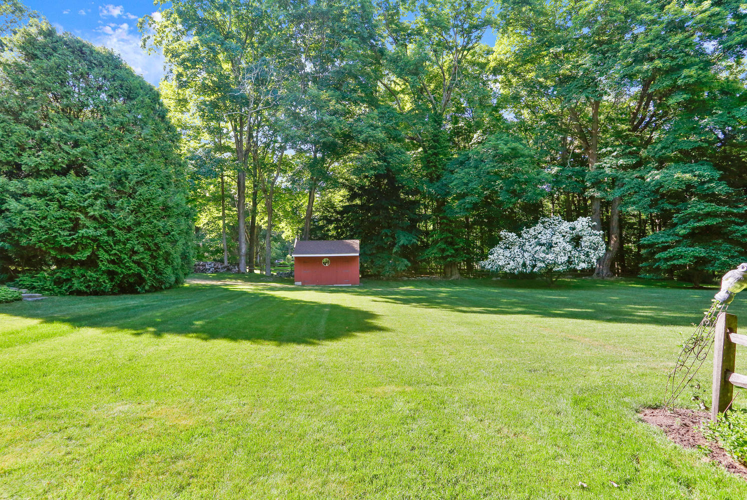573 Valley Road New Canaan, CT 06840 - Photo 38 of 53 a view of a house with a yard
