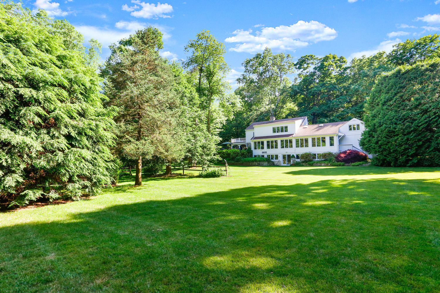 573 Valley Road New Canaan, CT 06840 - Photo 39 of 53 a view of house with a big yard