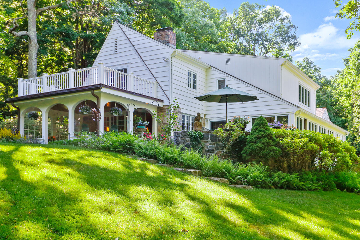 573 Valley Road New Canaan, CT 06840 - Photo 4 of 53 a view of a house with backyard and garden