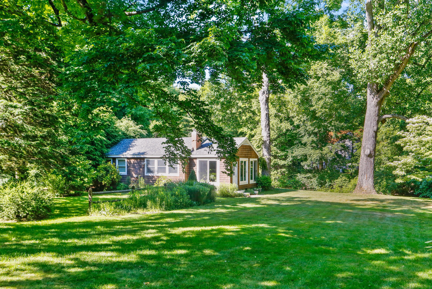 573 Valley Road New Canaan, CT 06840 - Photo 41 of 53 a front view of a house with a yard