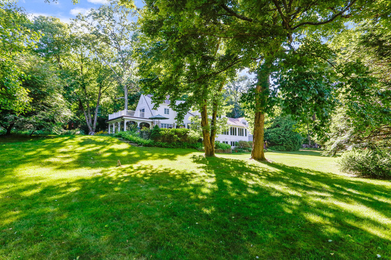 573 Valley Road New Canaan, CT 06840 - Photo 42 of 53 a house view with a sitting space and garden