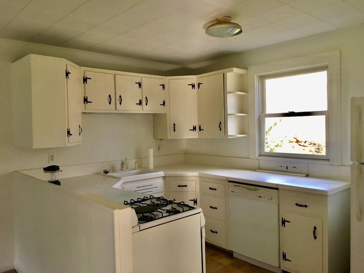 573 Valley Road New Canaan, CT 06840 - Photo 50 of 53 a kitchen with granite countertop a sink a stove and cabinets