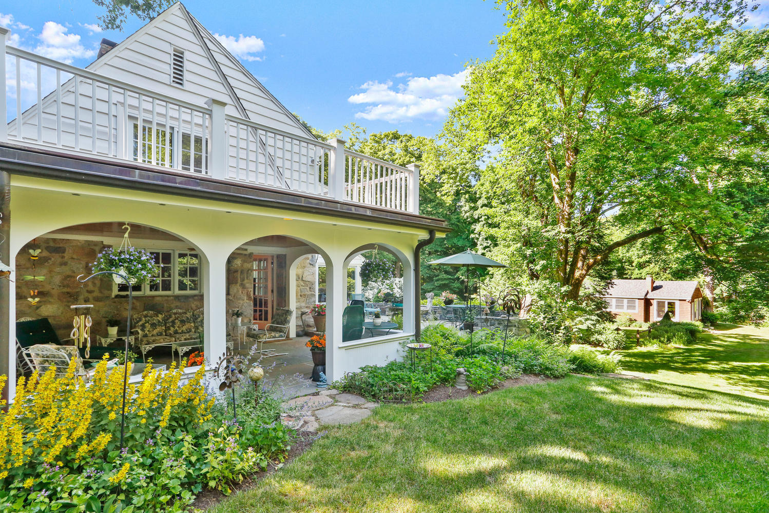 573 Valley Road New Canaan, CT 06840 - Photo 5 of 53 a front view of a house with garden