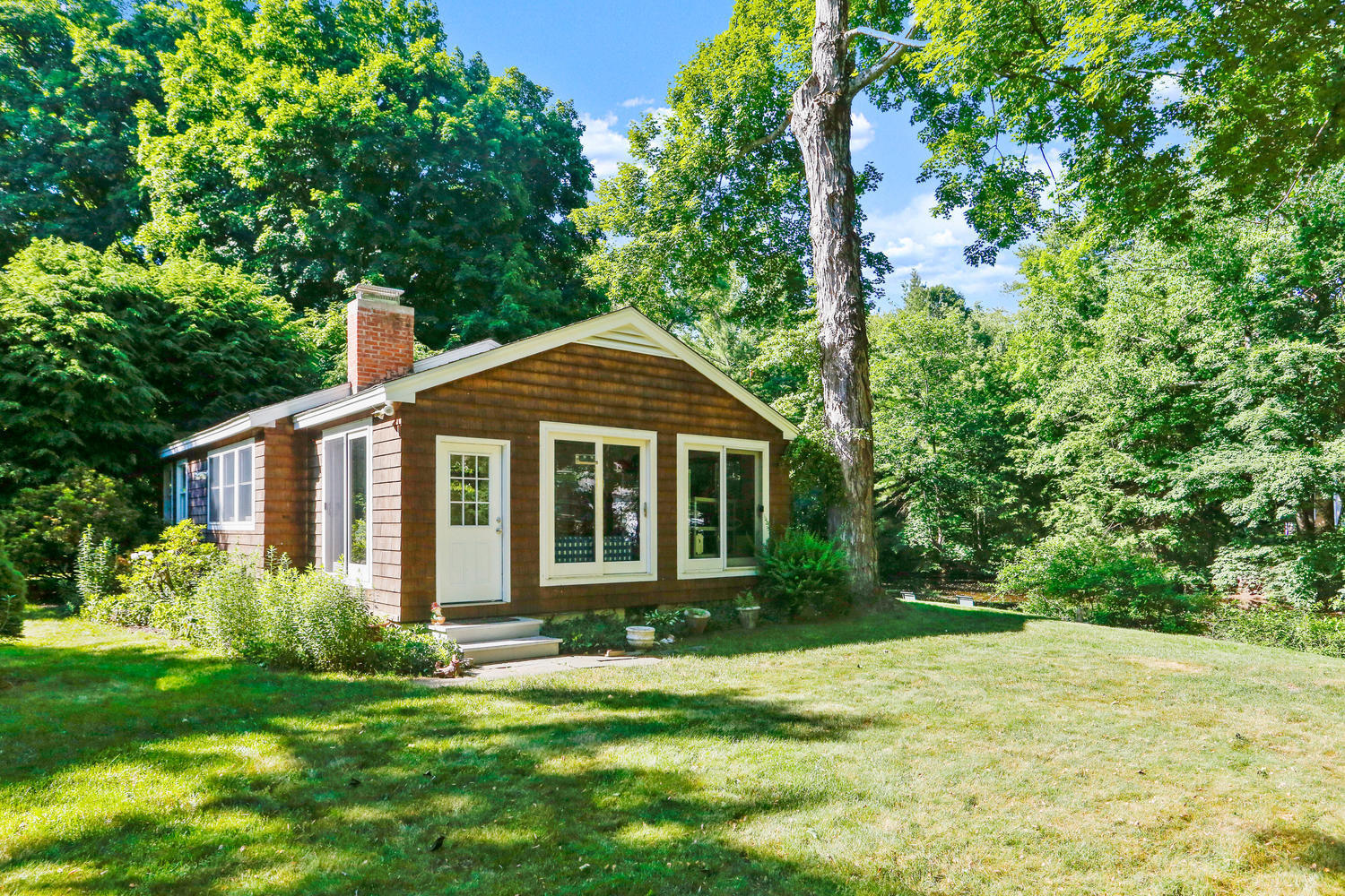 573 Valley Road New Canaan, CT 06840 - Photo 6 of 53 a front view of a house with a yard