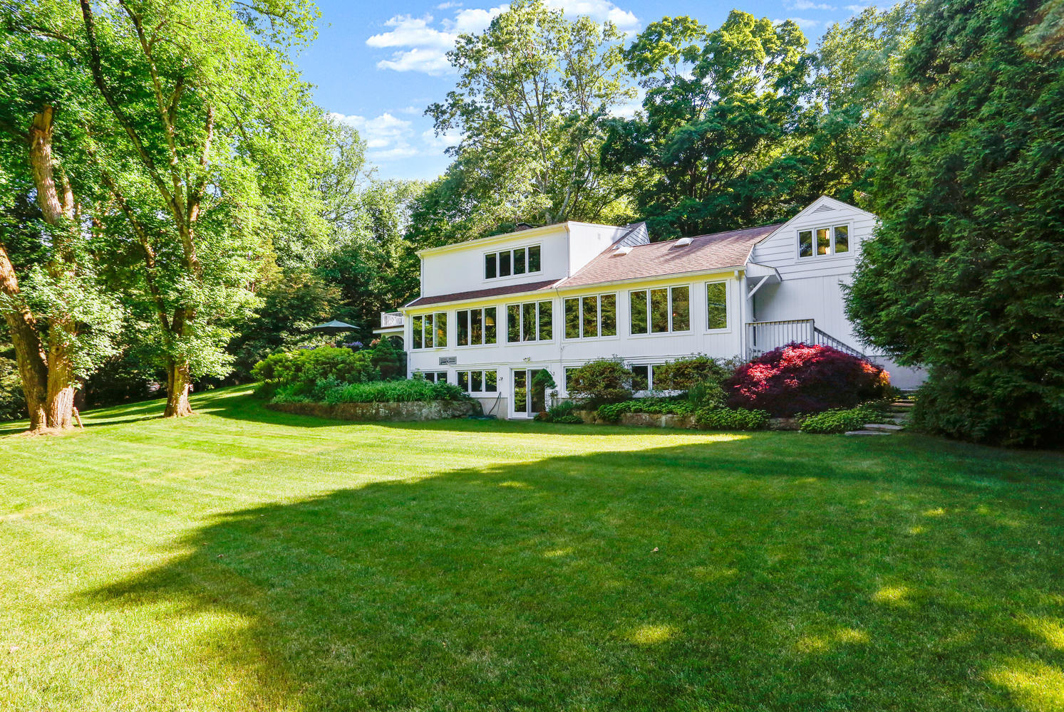 573 Valley Road New Canaan, CT 06840 - Photo 7 of 53 a front view of a house with garden