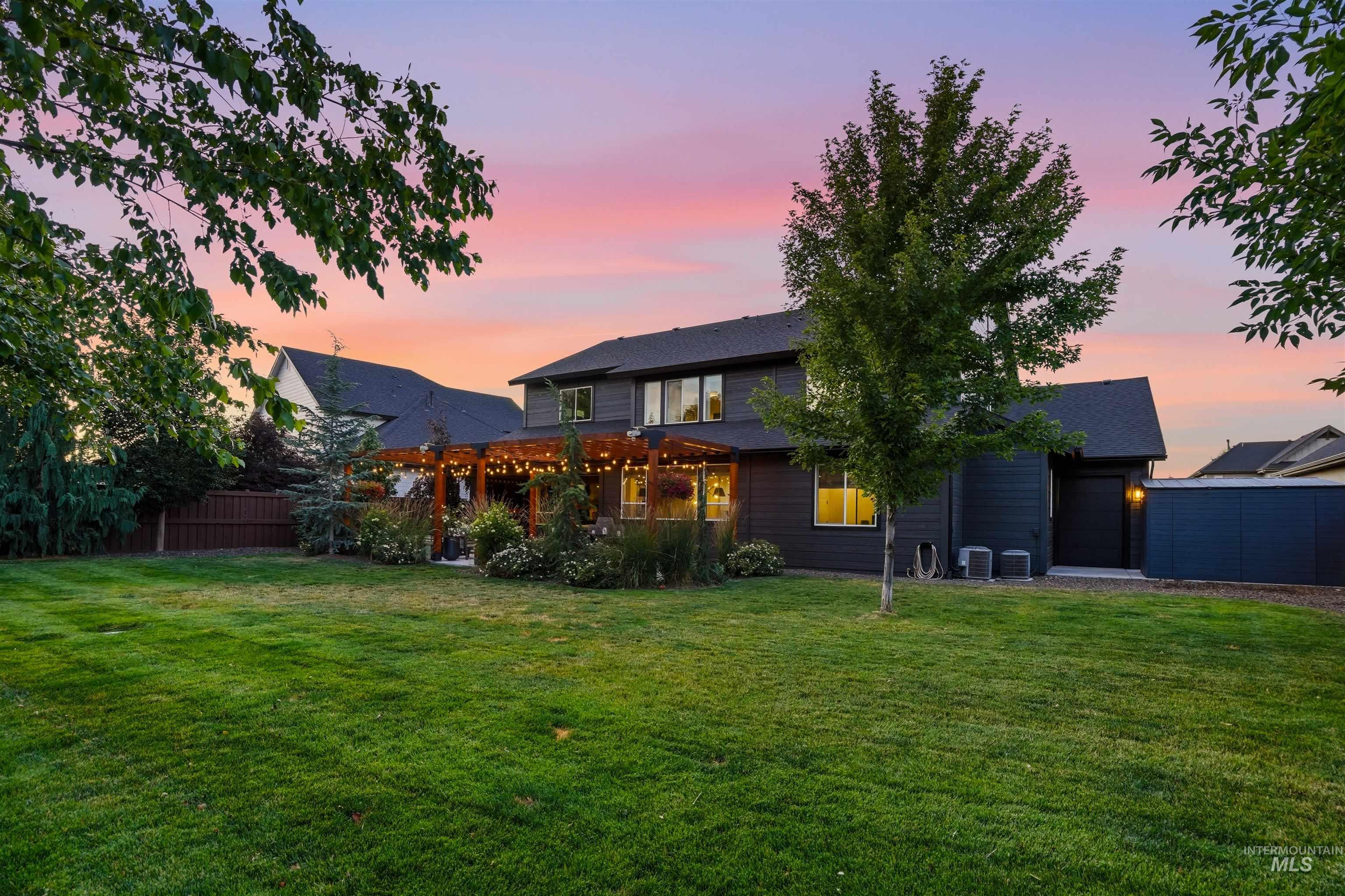 4323 West Ladle Rpds Drive Meridian, ID 83646 - Photo 45 of 49 Expansive backyard featuring a lush lawn, mature trees, and a wooden pergola covering a patio area