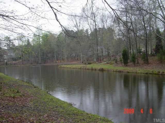 11808 Coachmans Way Raleigh, NC 27614 - Photo 11 of 12 a view of a lake with a yard and large trees