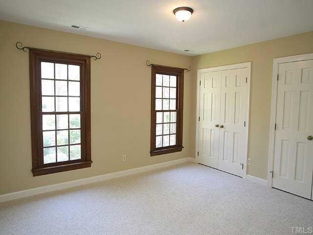 11808 Coachmans Way Raleigh, NC 27614 - Photo 9 of 12 an empty room with windows and closet