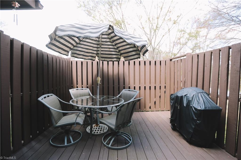 3103 Rockingham Road High Point, NC 27265 - Photo 22 of 22 Rear of home feature patio, and fully fenced back deck. This area is perfect for our lovely NC weather. Back also features storage room.