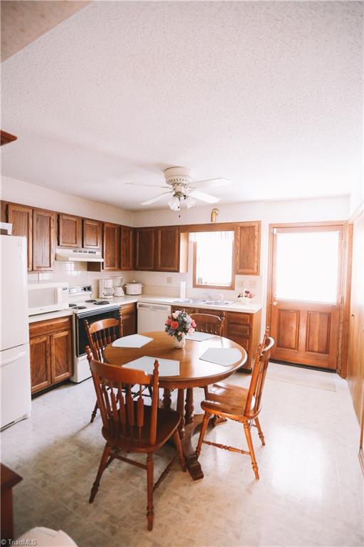 3103 Rockingham Road High Point, NC 27265 - Photo 6 of 22 Eat-in kitchen features tons of cabinet space, lots of natural light, ceiling fan, and brand new dishwasher.