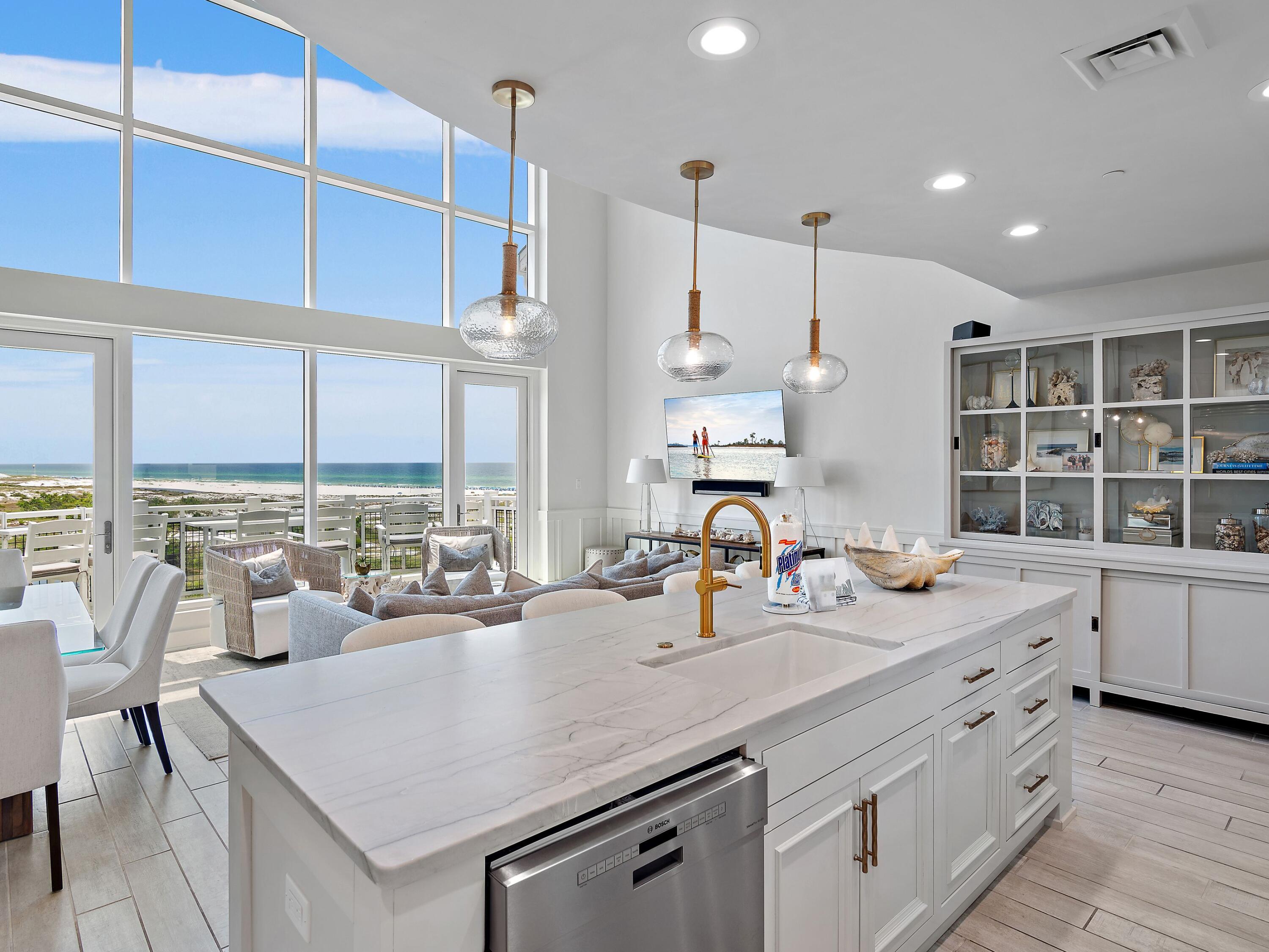 a kitchen with kitchen island a large counter top space a sink stainless steel appliances and cabinets