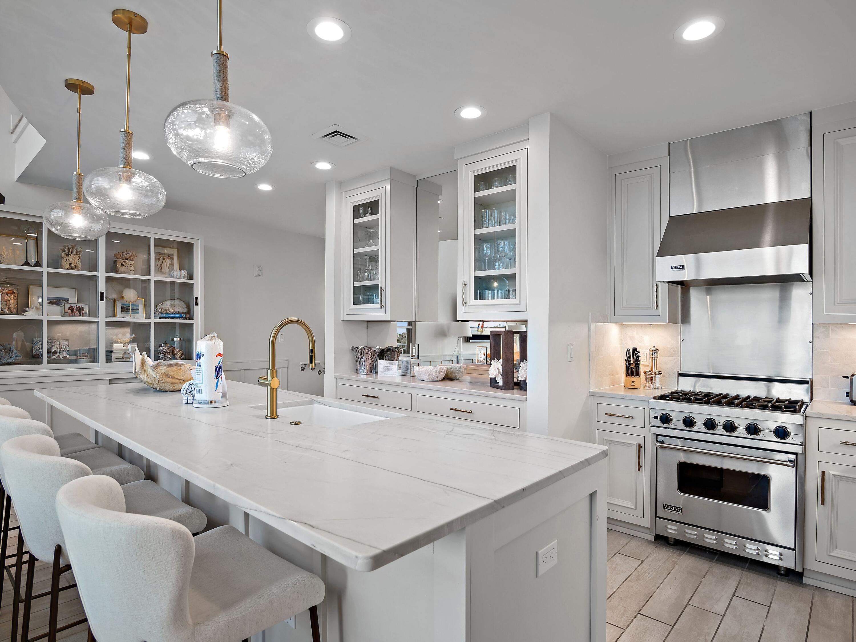 37 Compass Point Way South, Unit 421 Inlet Beach, FL 32461 - Photo 8 of 30 a kitchen with kitchen island granite countertop a stove a sink a dining table and chairs