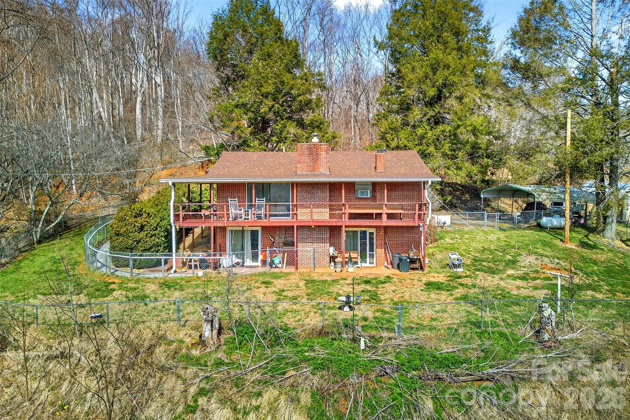 1306 Fork Mountain Road Bakersville, NC 28705 - Photo 2 of 34 a view of a house with yard and sitting area