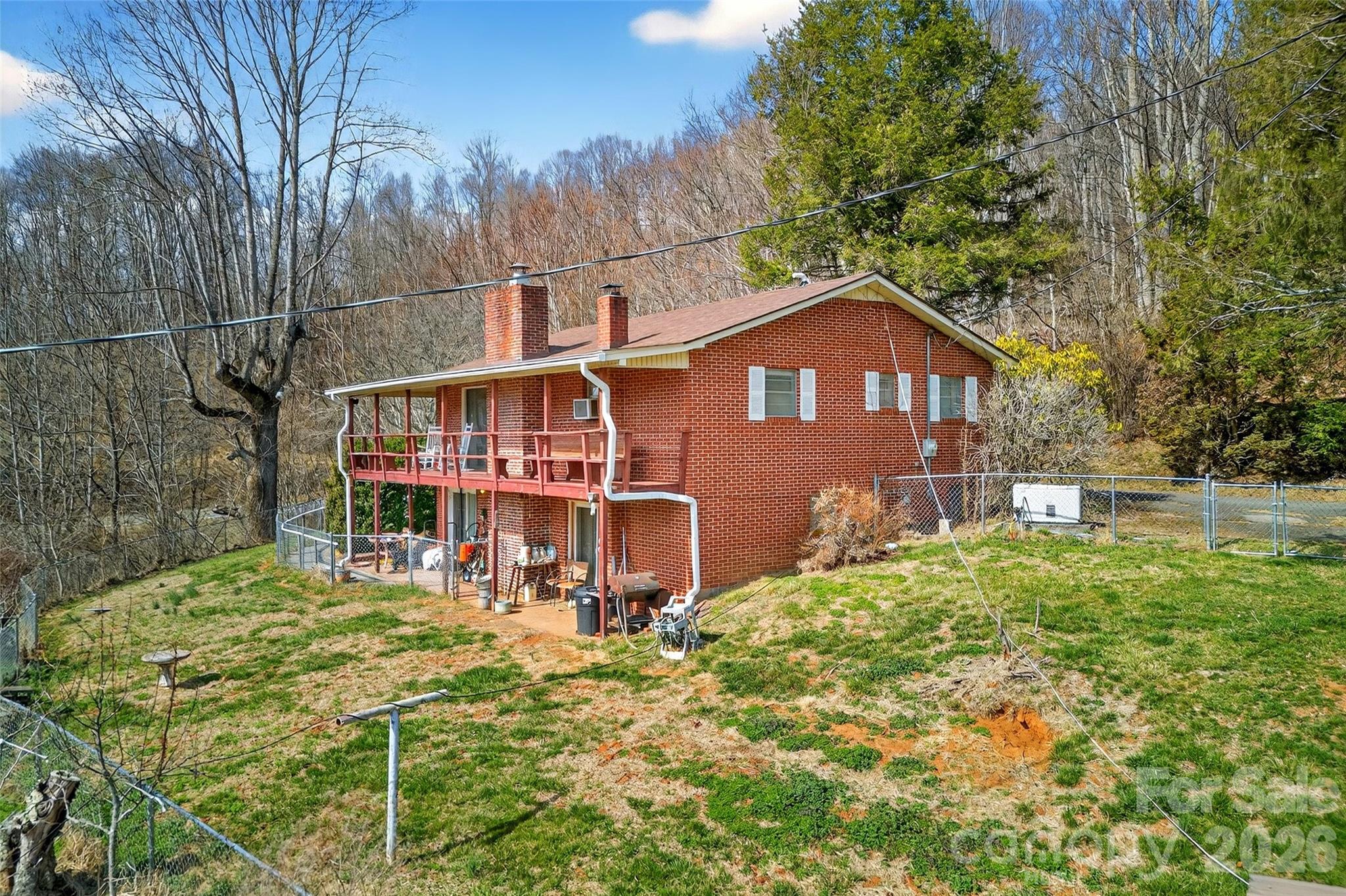 1306 Fork Mountain Road Bakersville, NC 28705 - Photo 3 of 34 a front view of a house with a yard