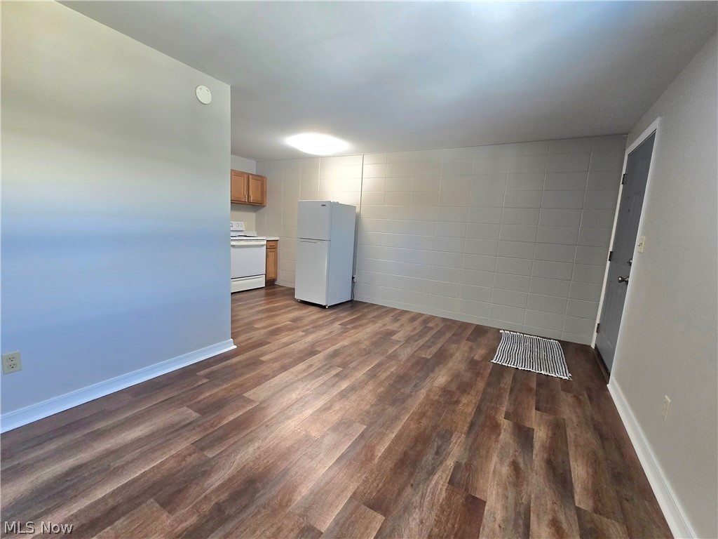 909 Garden Road Zanesville, OH 43701 - Photo 3 of 8 Spare room featuring dark wood-type flooring and baseboards