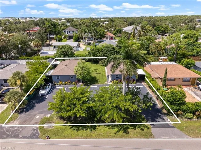an aerial view of residential houses with outdoor space and street view
