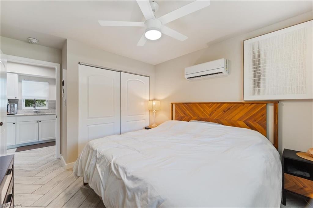 3365-3367 Estey Avenue Naples, FL 34104 - Photo 12 of 30 a bedroom with a bed and a flat screen tv