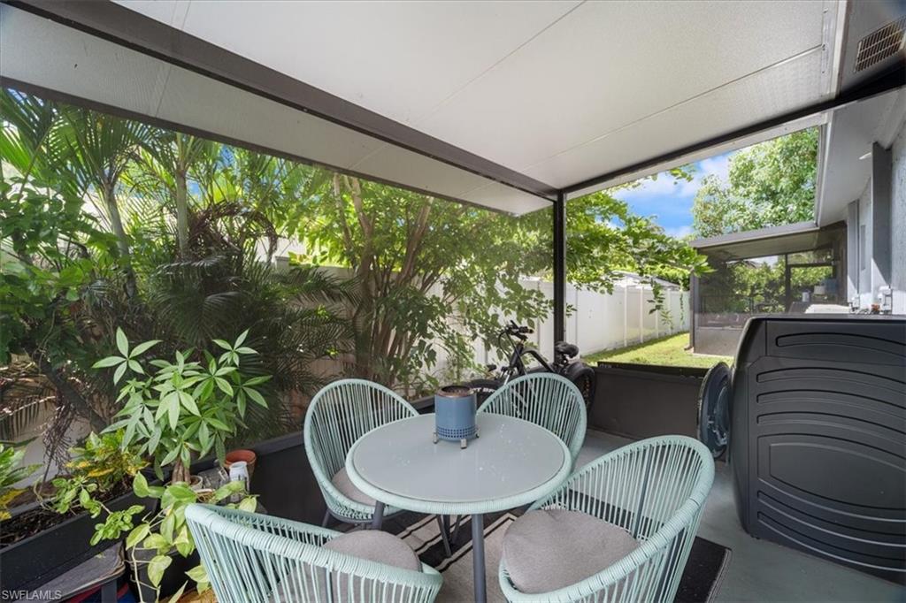 3365-3367 Estey Avenue Naples, FL 34104 - Photo 13 of 30 a living room with furniture and a potted plant