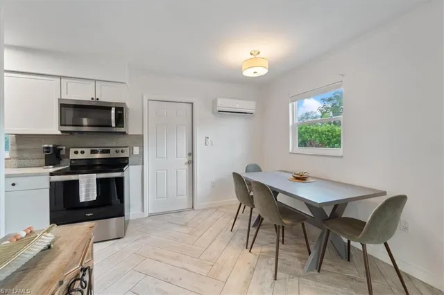 a kitchen that has a table and chairs in it