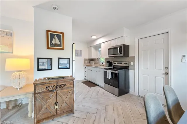 a kitchen with granite countertop a stove top oven and a sink