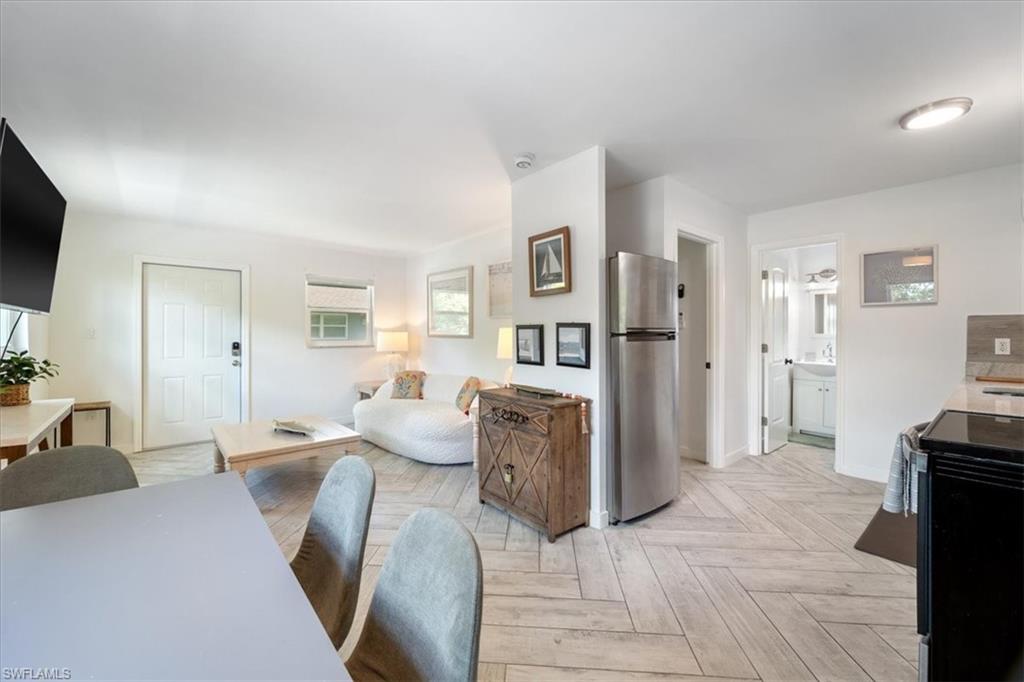 3365-3367 Estey Avenue Naples, FL 34104 - Photo 19 of 30 a living room with furniture and a flat screen tv