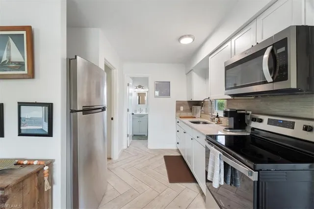 a kitchen with stainless steel appliances a stove microwave and a refrigerator