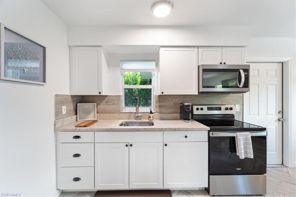 3365-3367 Estey Avenue Naples, FL 34104 - Photo 21 of 30 a kitchen with a sink stove and microwave