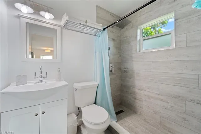 a white toilet sitting next to a bathroom sink