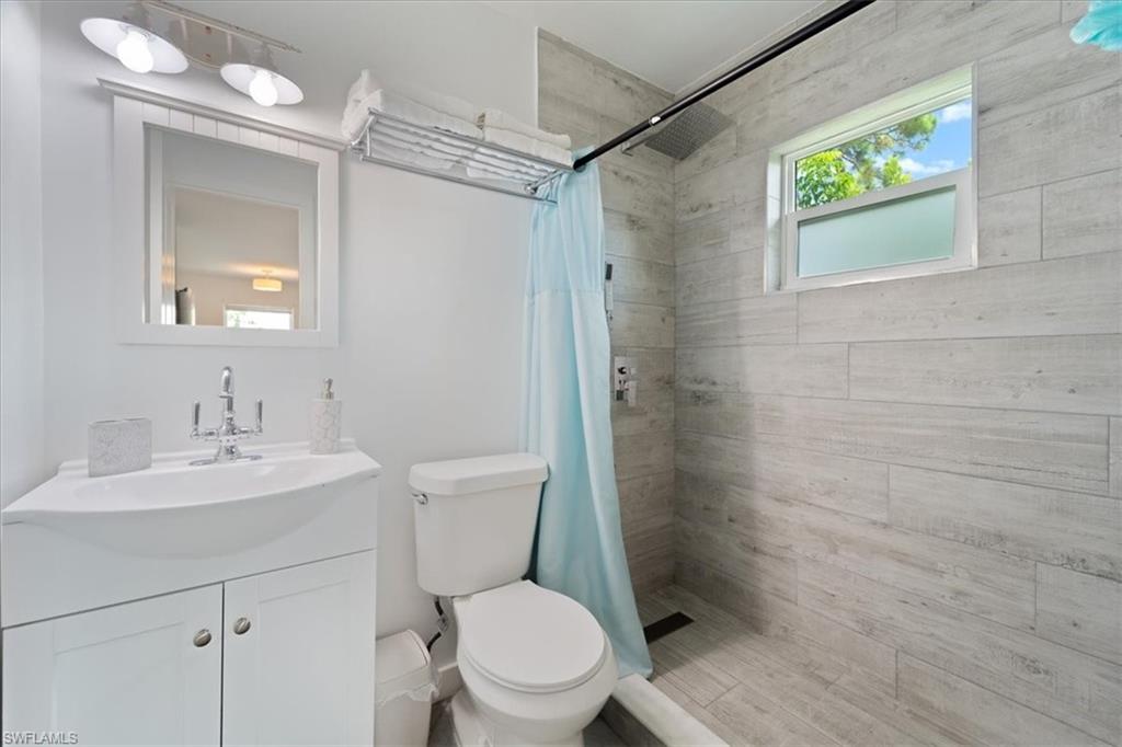 3365-3367 Estey Avenue Naples, FL 34104 - Photo 22 of 30 a white toilet sitting next to a bathroom sink