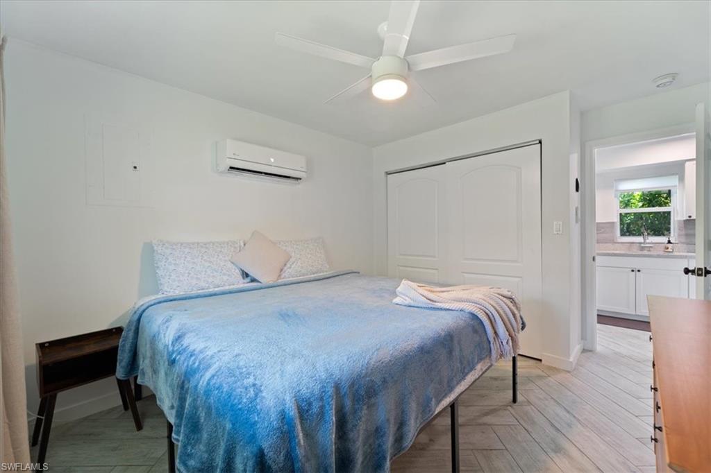 3365-3367 Estey Avenue Naples, FL 34104 - Photo 24 of 30 a bedroom with a bed and a table