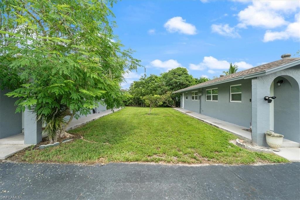 3365-3367 Estey Avenue Naples, FL 34104 - Photo 27 of 30 a backyard of a house with plants and trees