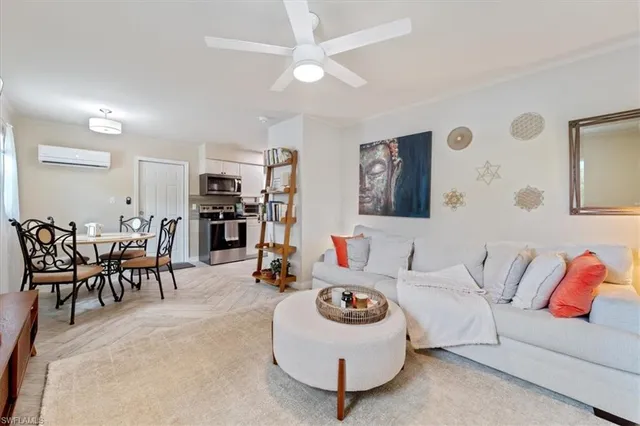 a living room with furniture and kitchen view