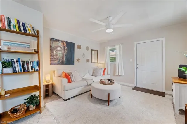 a living room with furniture and a book shelf